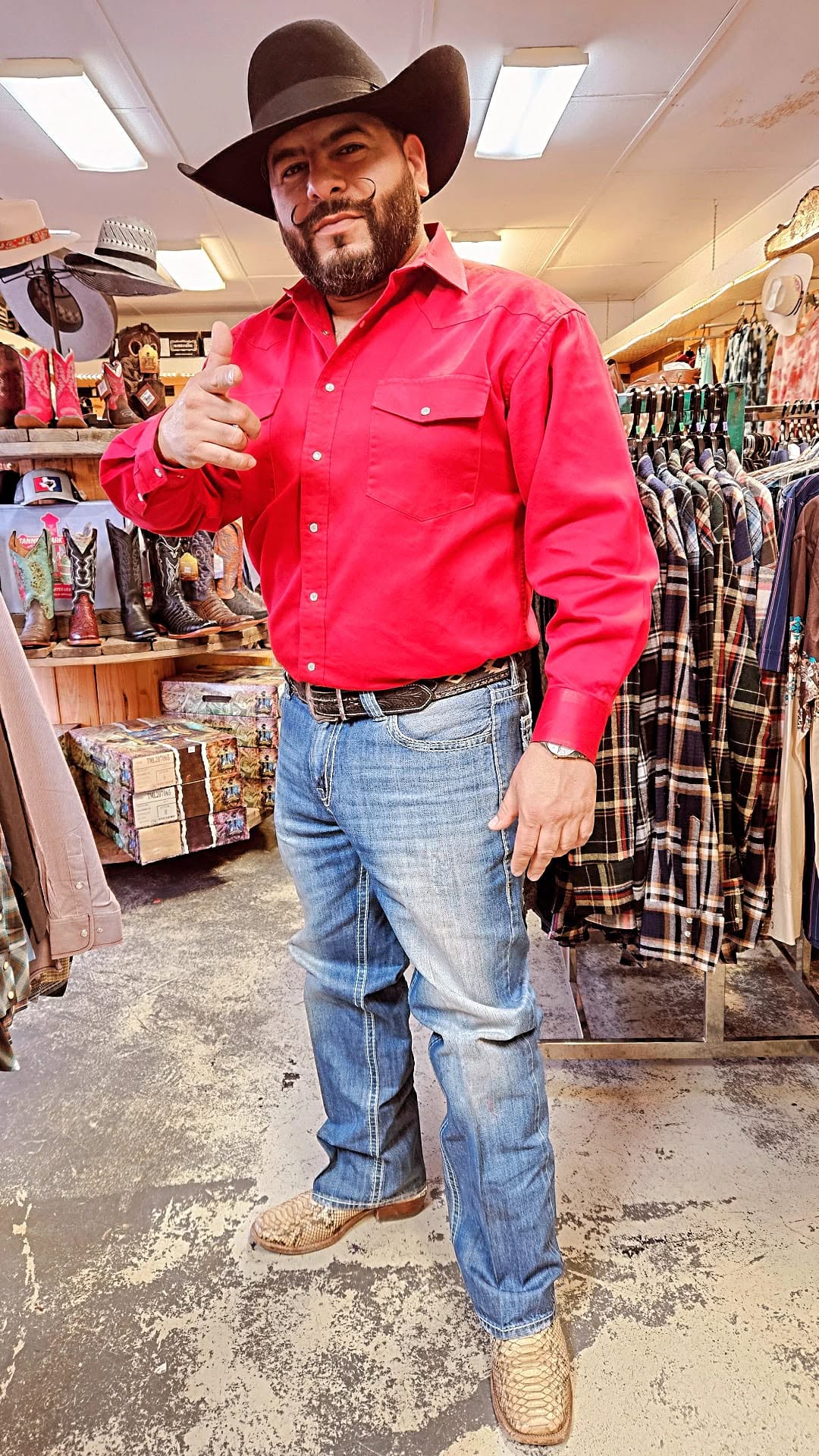 Tex Ruiz, owner of Take the Reins Western Wear, on the store floor
